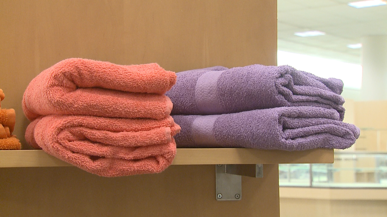 Towels line a shelf at a donation center for victims of the Marshall Fire (KDVR)