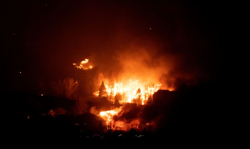 Flames engulf homes at night