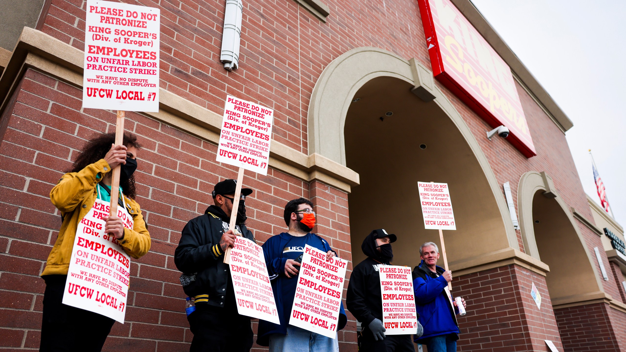 Workers At Grocery Chain King Soopers On Strike with SIgns outside a store