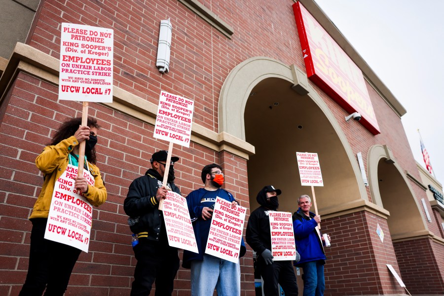 Workers At Grocery Chain King Soopers On Strike with SIgns outside a store