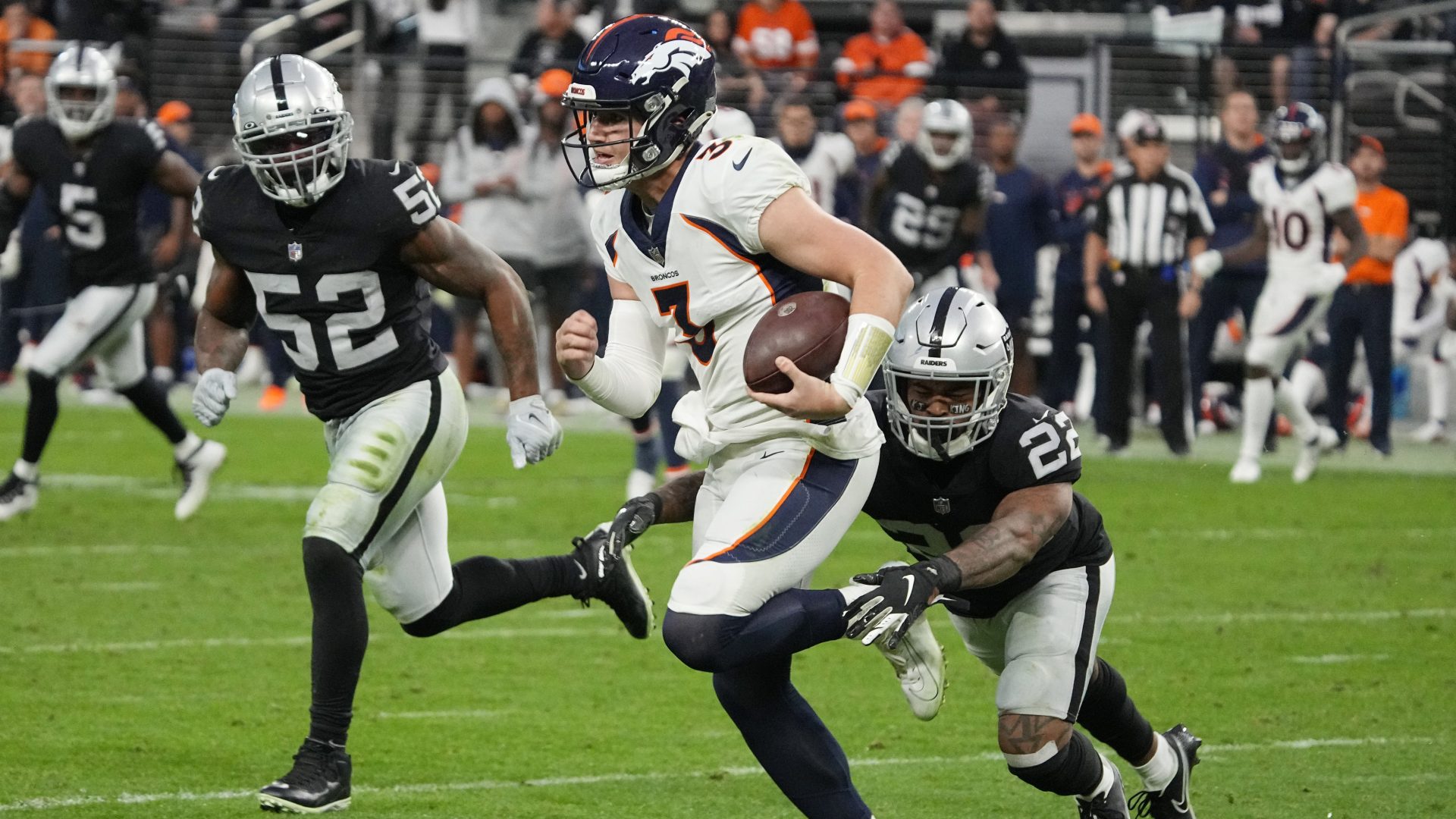 Las Vegas Raiders defensive back Keisean Nixon (22) tackles Denver Broncos quarterback Drew Lock (3) during the second half of an NFL football game, Sunday, Dec. 26, 2021, in Las Vegas.