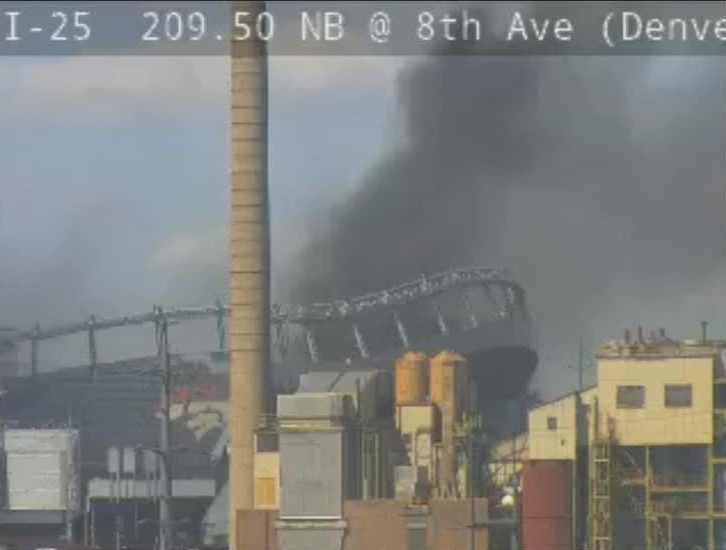 Smoke is seen from a fire at Empower Field at Mile High