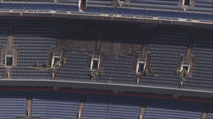 Firefighters at the scene of a fire at Empower Field at Mile High