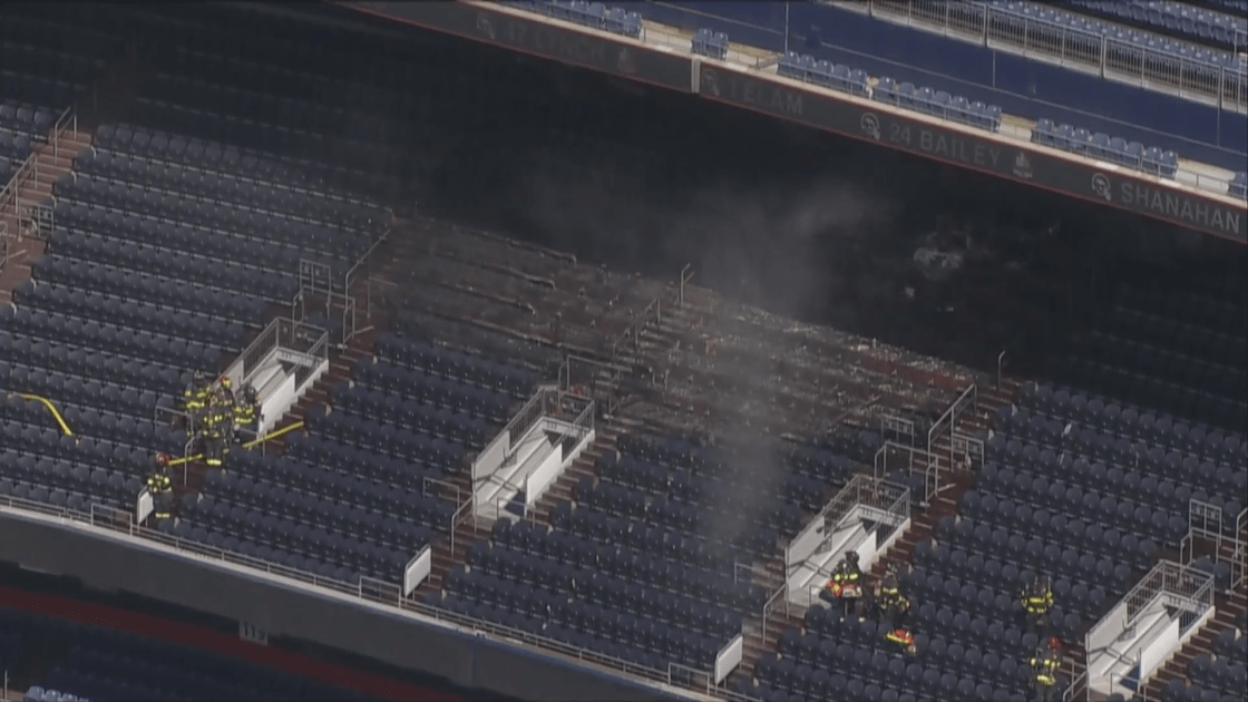 Firefighters at the scene of a fire at Empower Field at Mile High