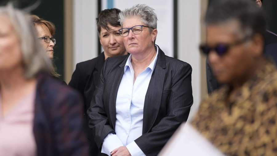 Robin Niceta stands behind her partner, former Aurora Police Chief Vanessa Wilson, at a rally on April 11, 2022 in Aurora.