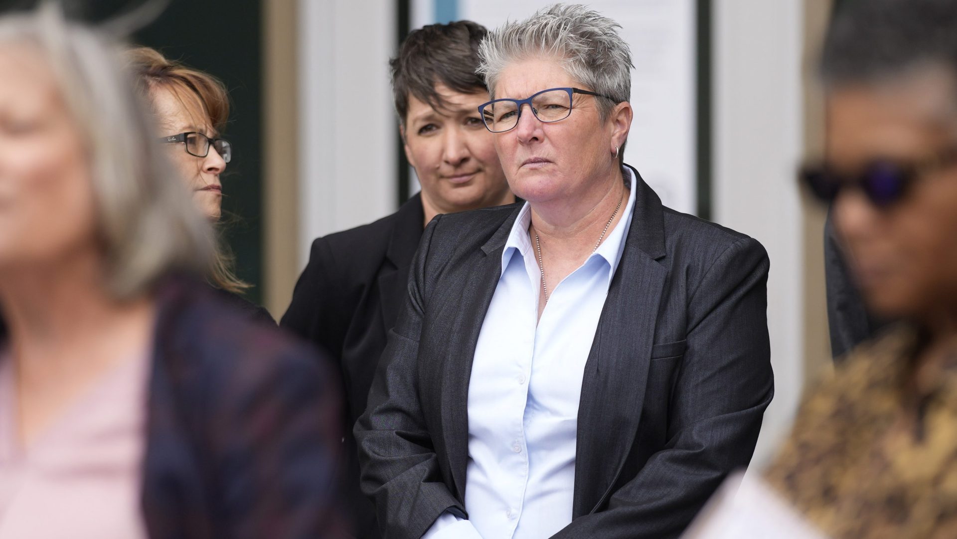 Robin Niceta stands behind her partner, former Aurora Police Chief Vanessa Wilson, at a rally on April 11, 2022 in Aurora.