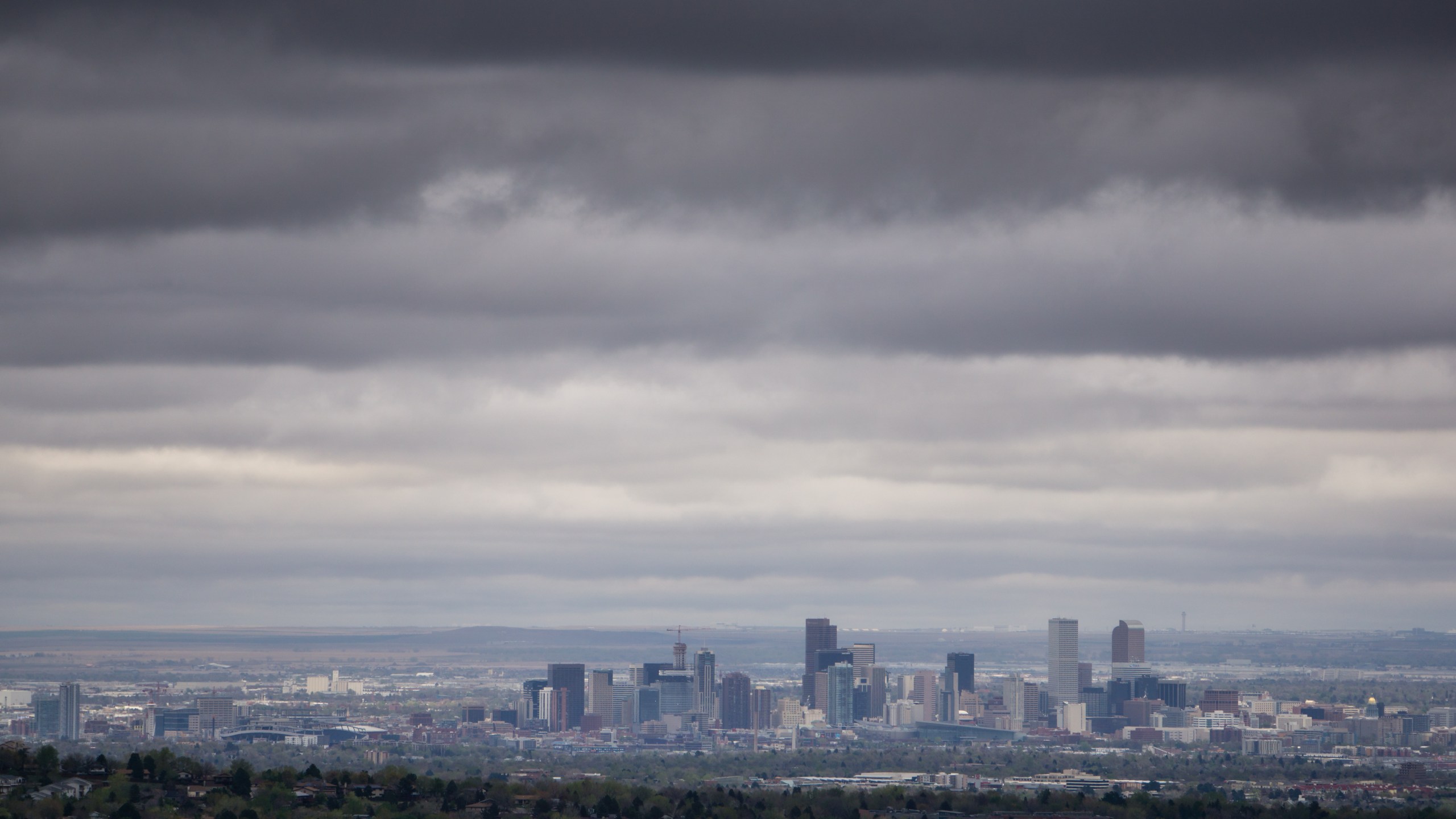 Wide-angle photo of Denver, Colorado skyline on a cloudy day