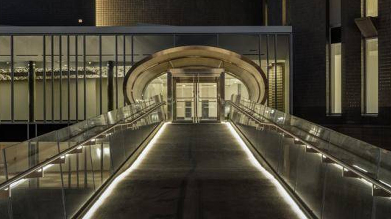 The Denver Art Museum's Martin Building Schlessman Family Bridge and group entrance at night.