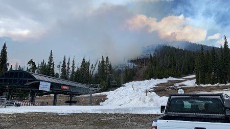 Smoke billows from above Keystone ski resort mountain