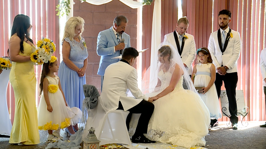 Bailey Jones and Daniel Pinson hold hands as they say their wedding vows