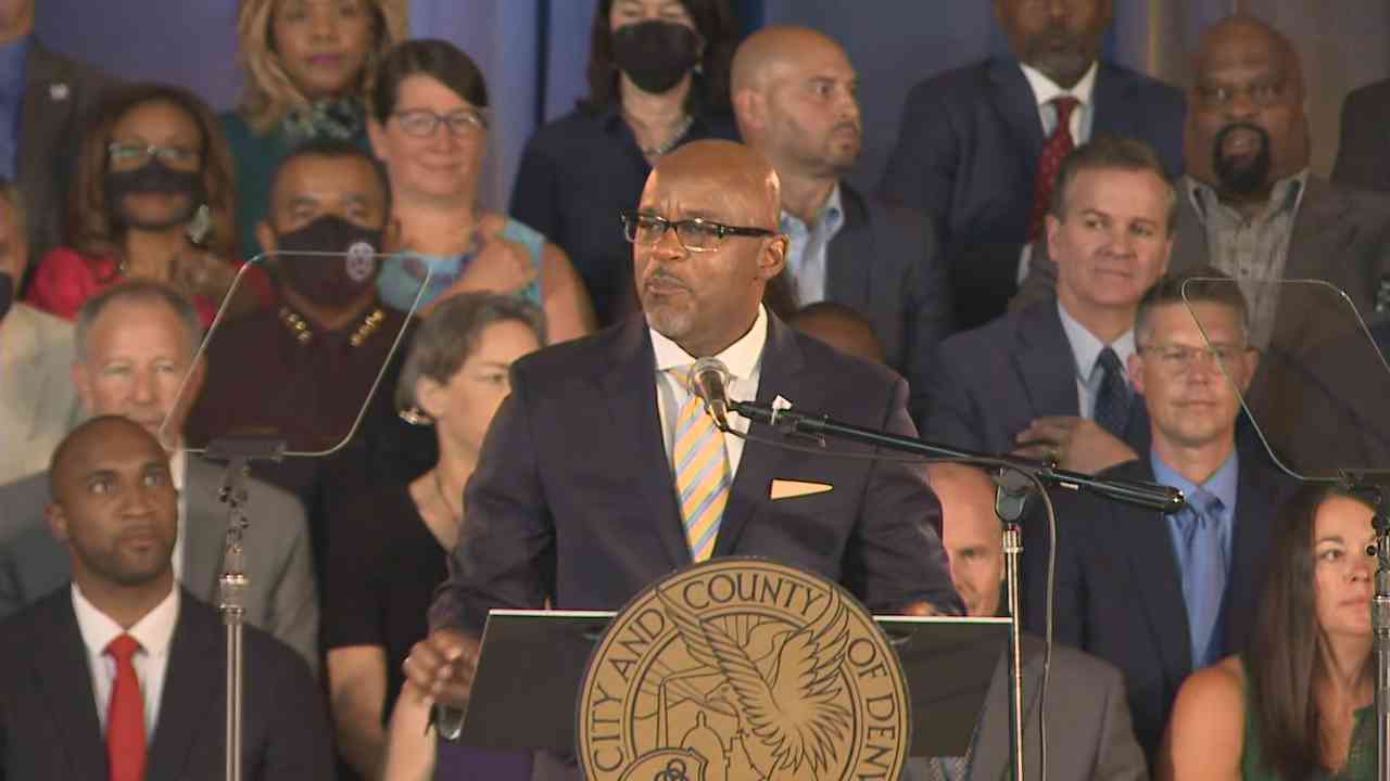 Denver Mayor Michael Hancock at the lectern before an audience