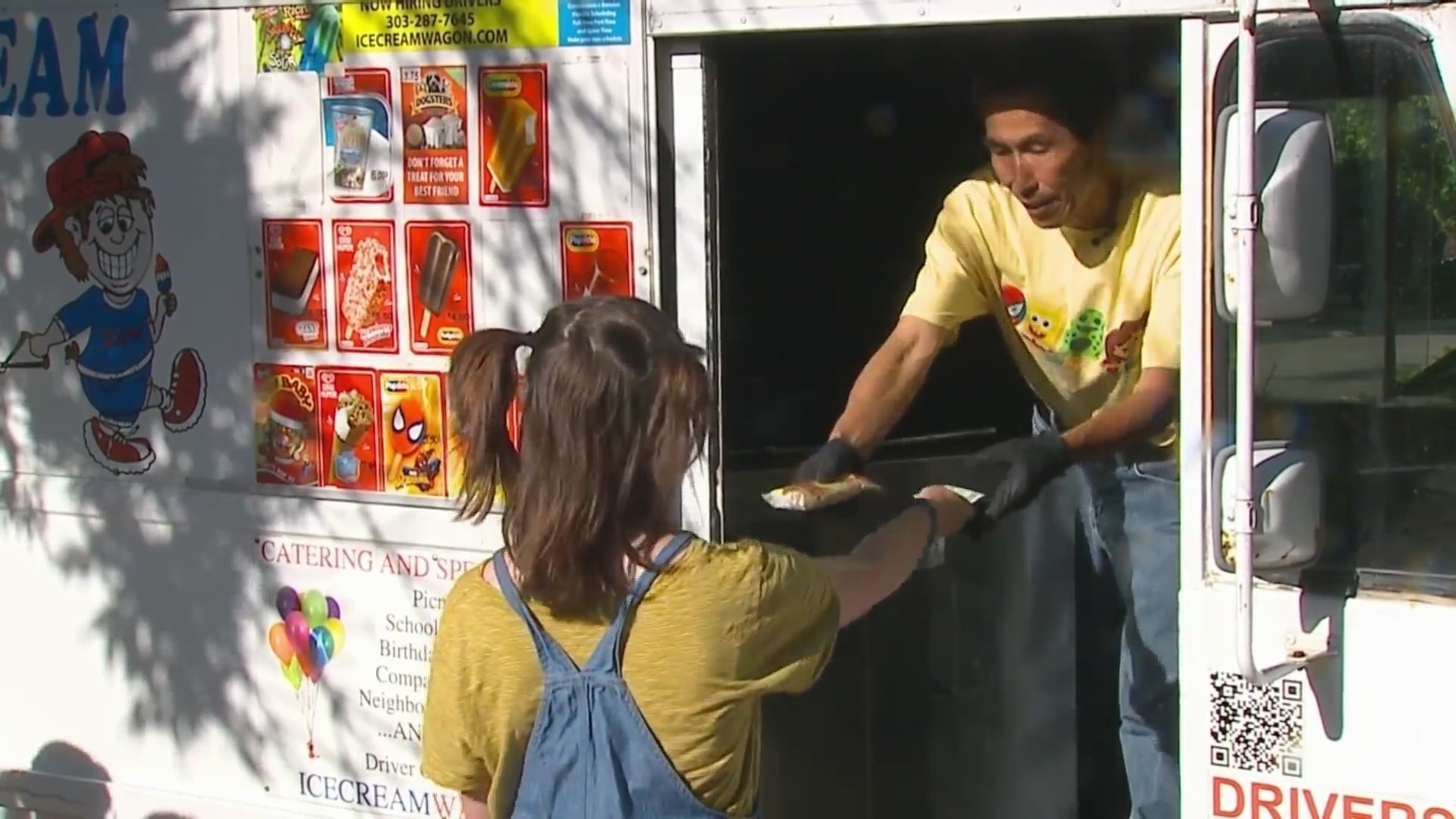 Child buys ice cream at ice cream truck