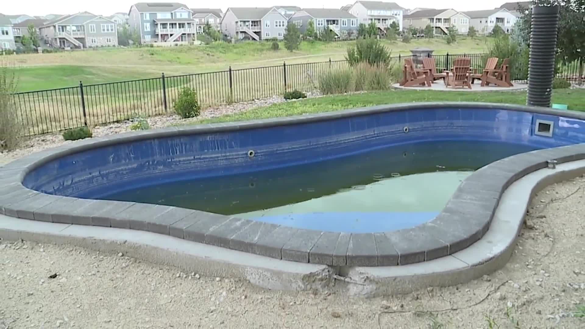 Unfinished pool in backyard