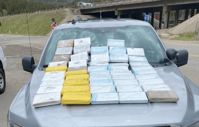 Packs of powdered fentanyl on hood of a car