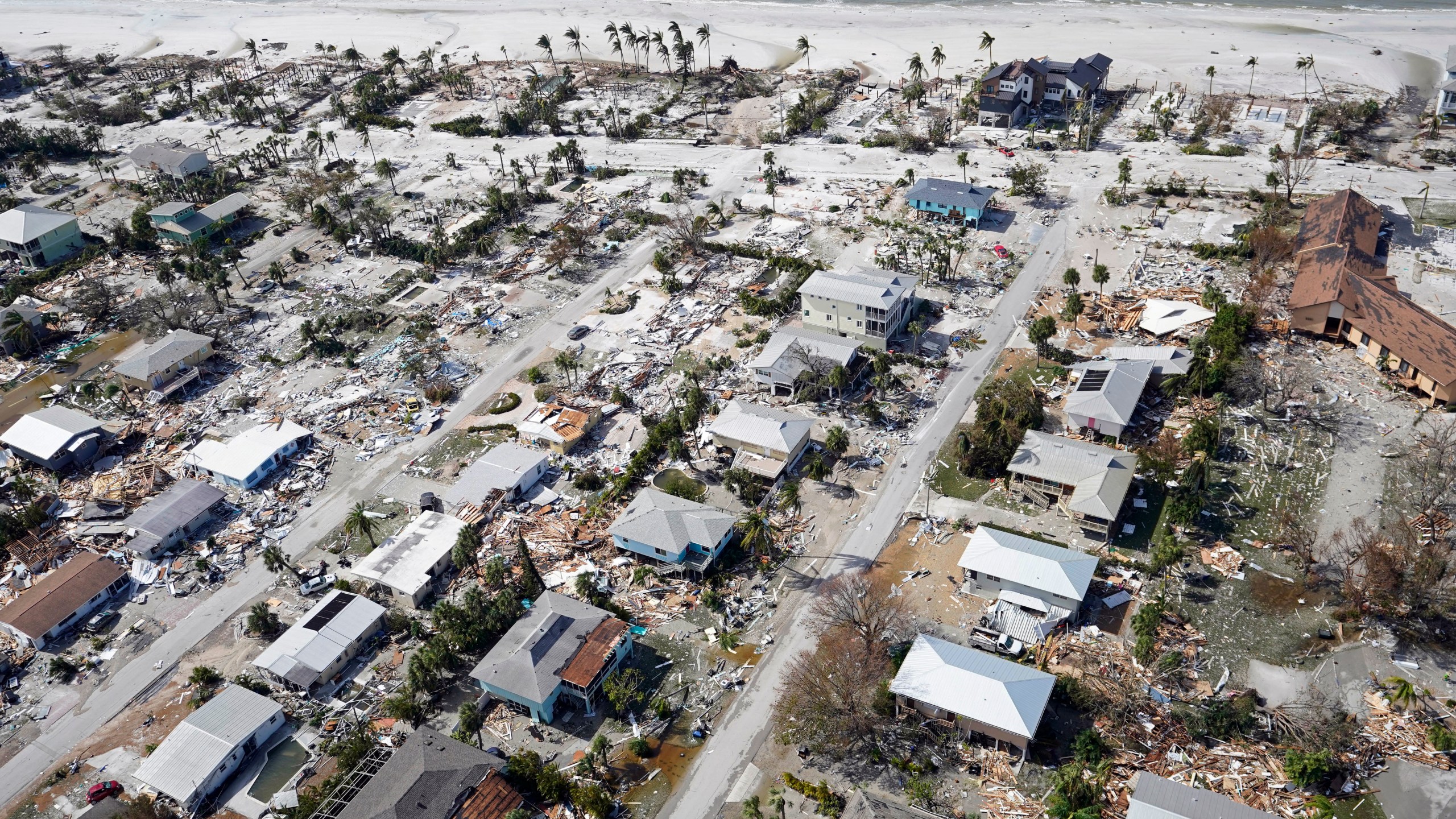 This aerial photo shows damaged homes and debris in the aftermath of Hurricane Ian, Thursday, Sept. 29, 2022, in Fort Myers, Fla.