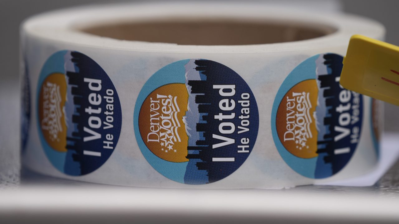 A roll of stickers sits on a bench to be distributed to voters after casting ballot at a polling site across from the Museum of Science and Nature Tuesday, Nov. 2, 2021, in east Denver.