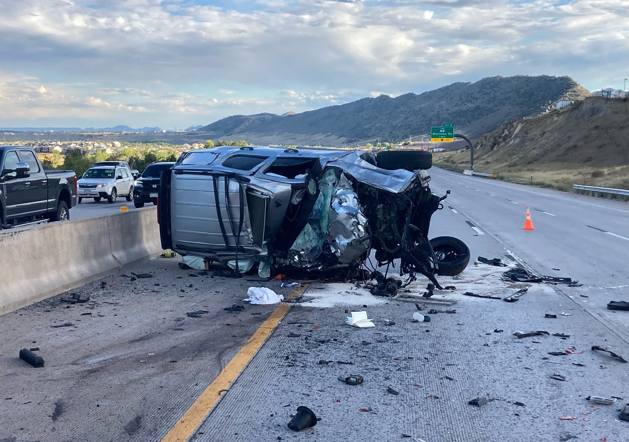 Destroyed vehicle on its side on the highway