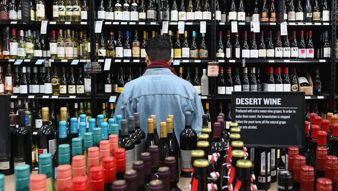 A patron stands in front of a shelf full of wine bottles at The Liquor Store.Com on March 20, 2020 in the Brooklyn borough of New York.