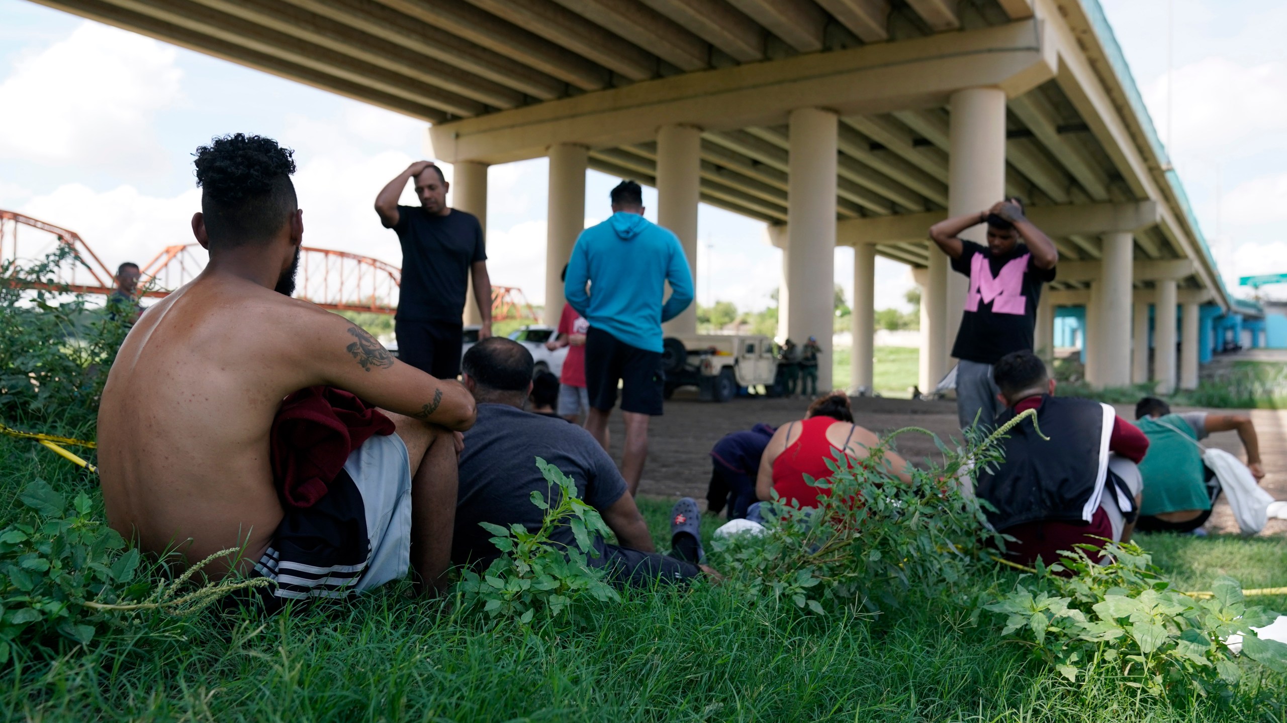 Migrants wait to be processed by Border Patrol