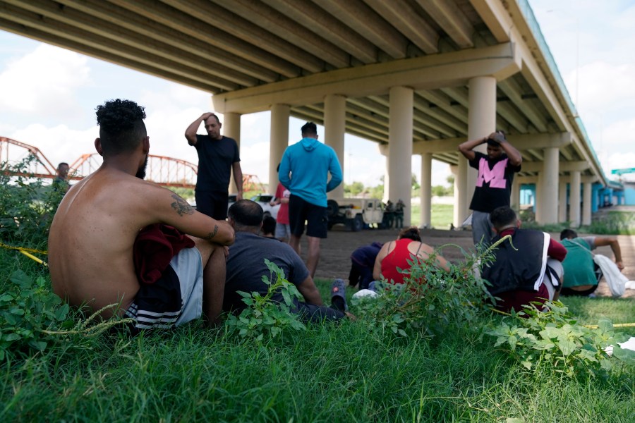 Migrants wait to be processed by Border Patrol