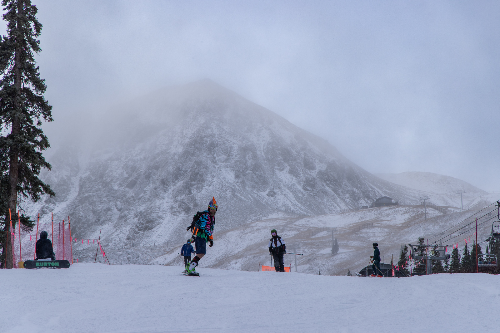 Colorful snowboarder heads down slopes at Arapahoe Bas