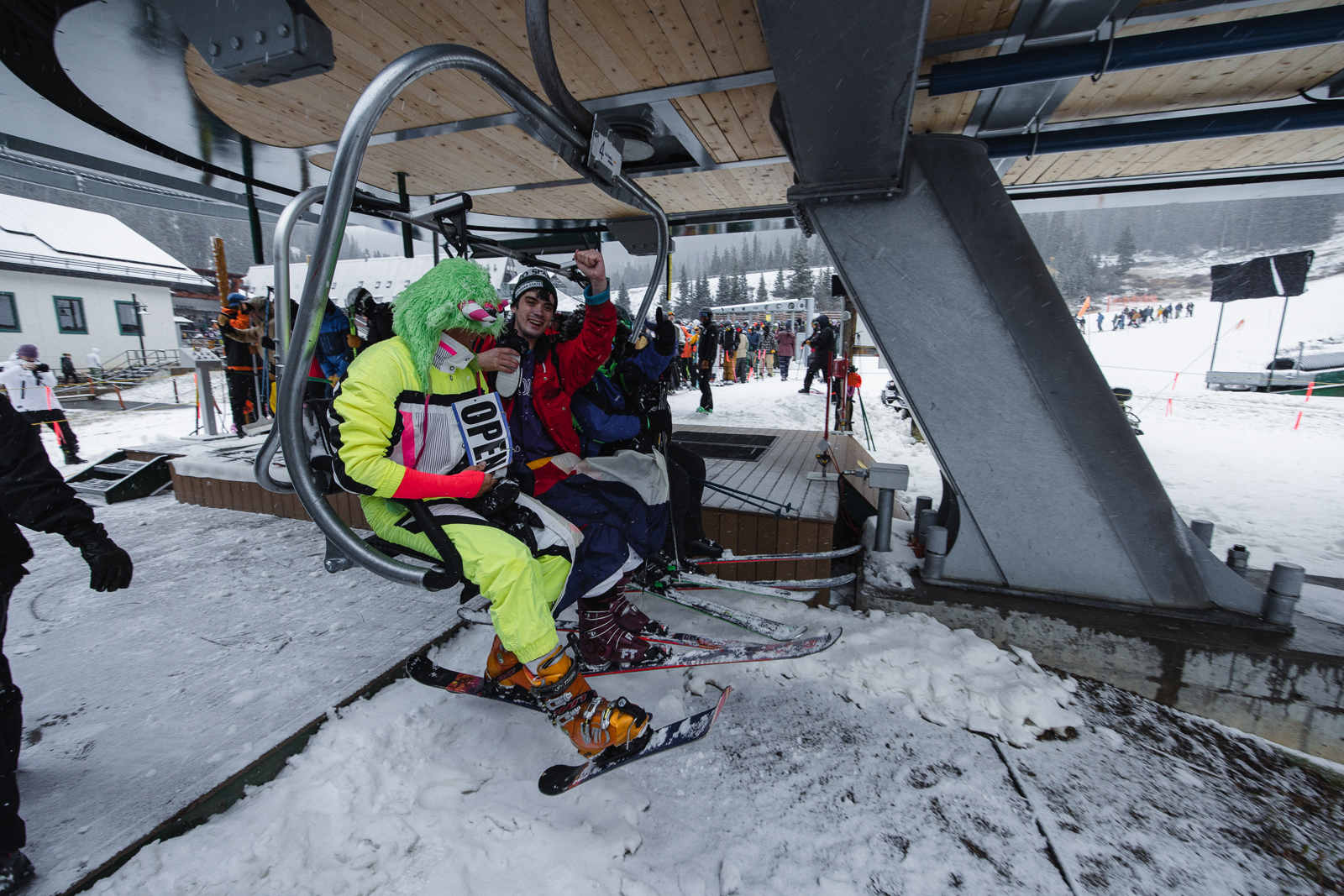 Snowboarders and skiers head up the lift at Arapahoe Basin on opening day