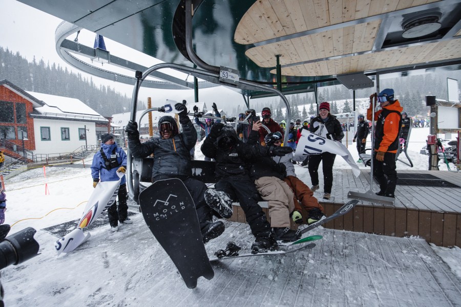 Snowboarders head up first chair at A-Basin on opening day