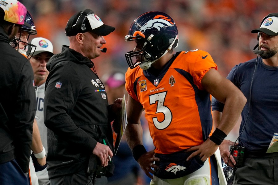 Russell Wilson (3) talks with head coach Nathaniel Hackett