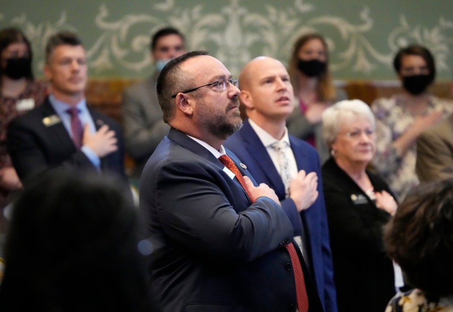 Colorado State Rep. Hugh McKean stands for the reciting of the Pledge of Allegiance