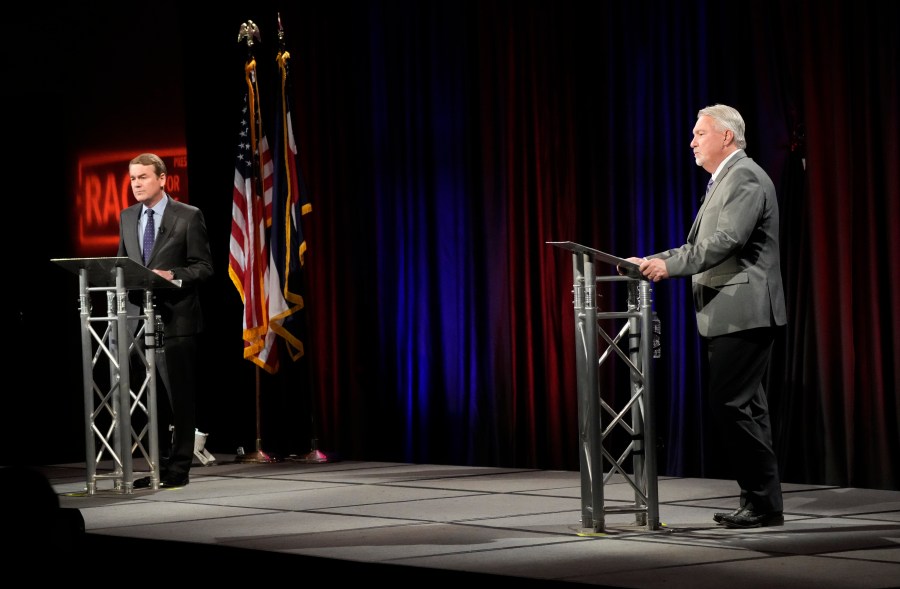 Michael Bennet, left, responds to a question during a debate with Joe O'Dea