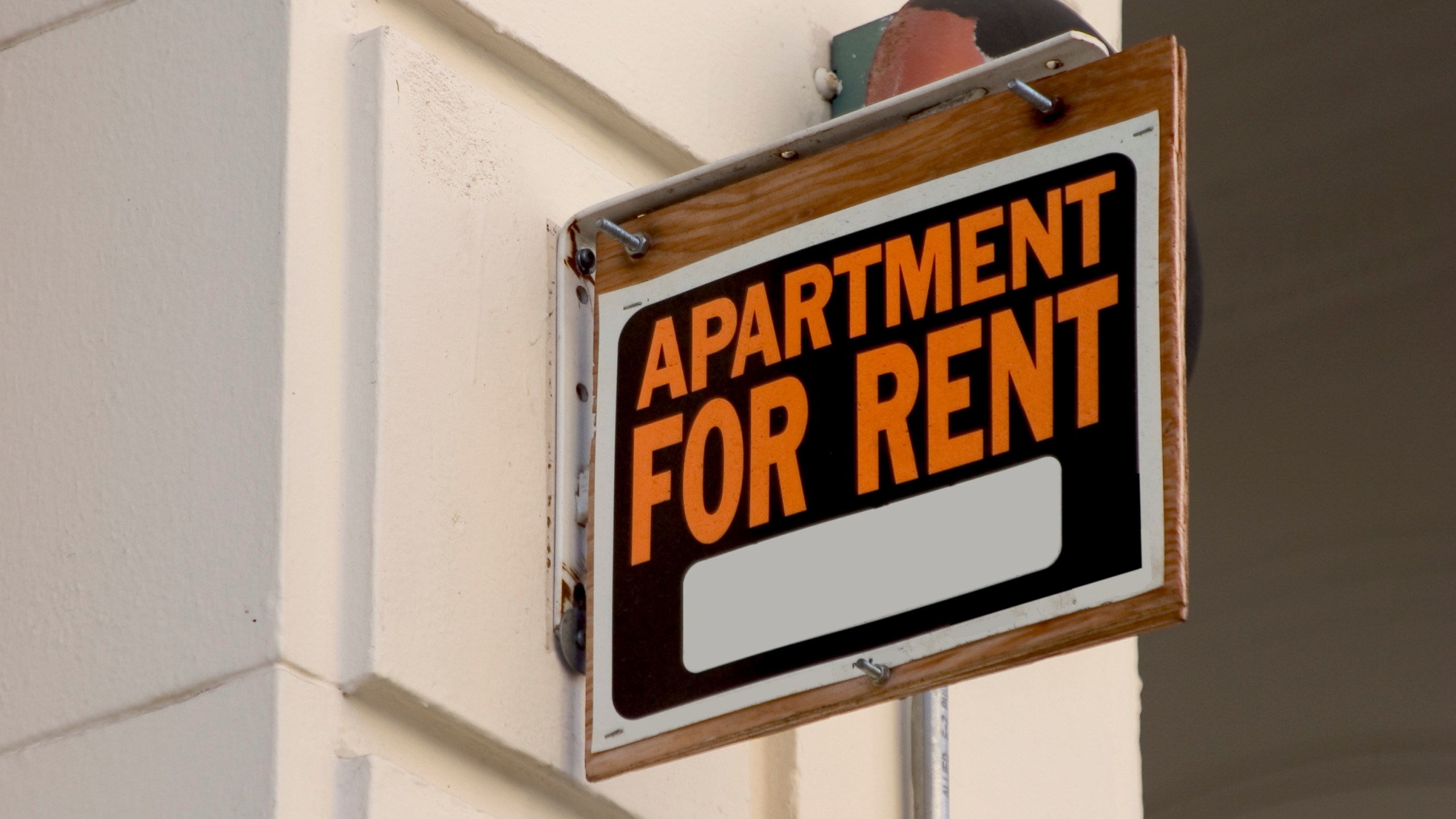 A for rent sign on display on the side of an apartment building