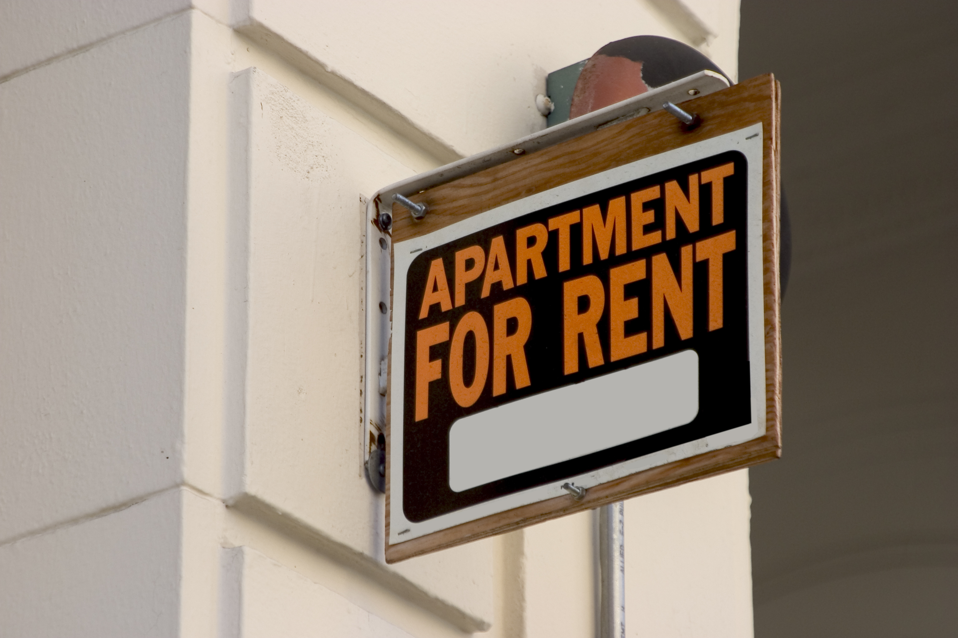 A for rent sign on display on the side of an apartment building