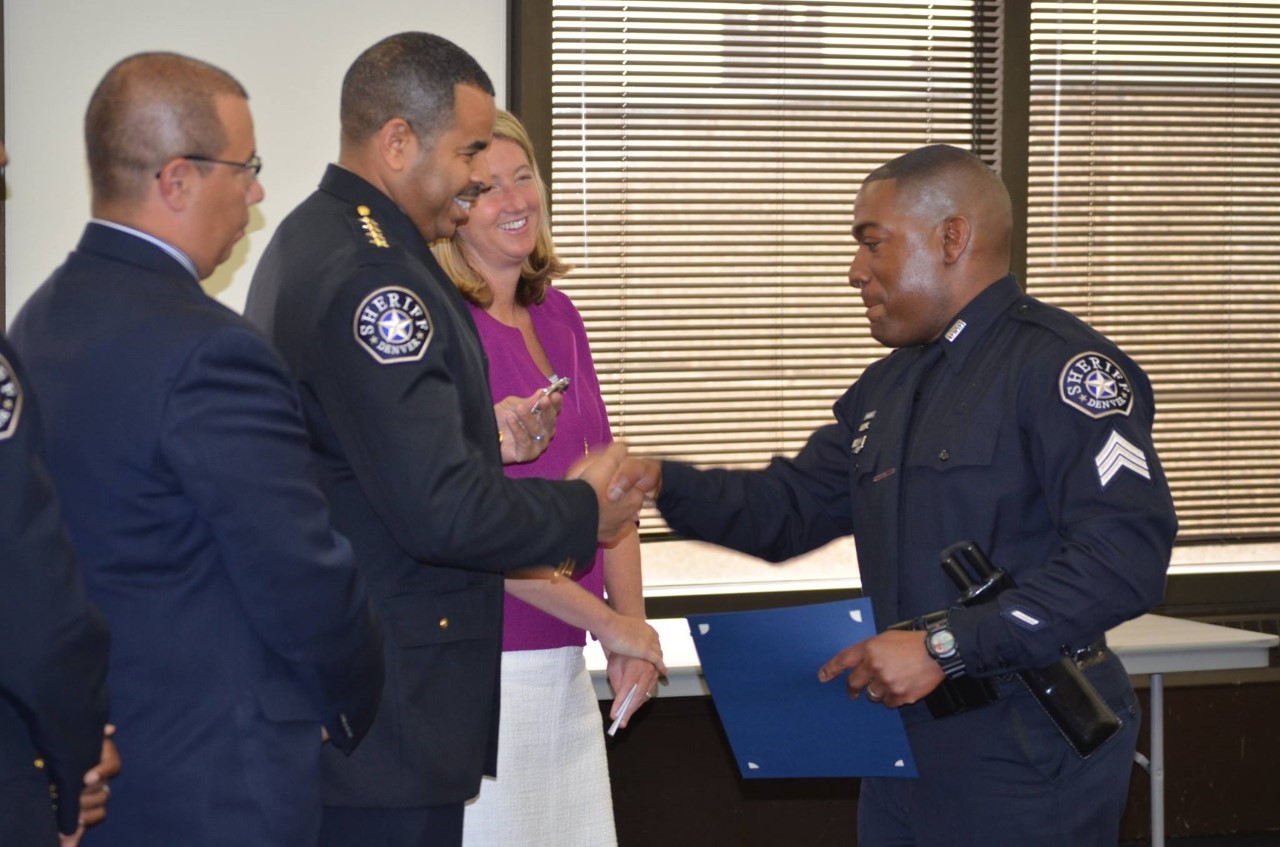 Sheriff Deputy Sherrod shakes hands with Denver Sheriff Elias Diggins