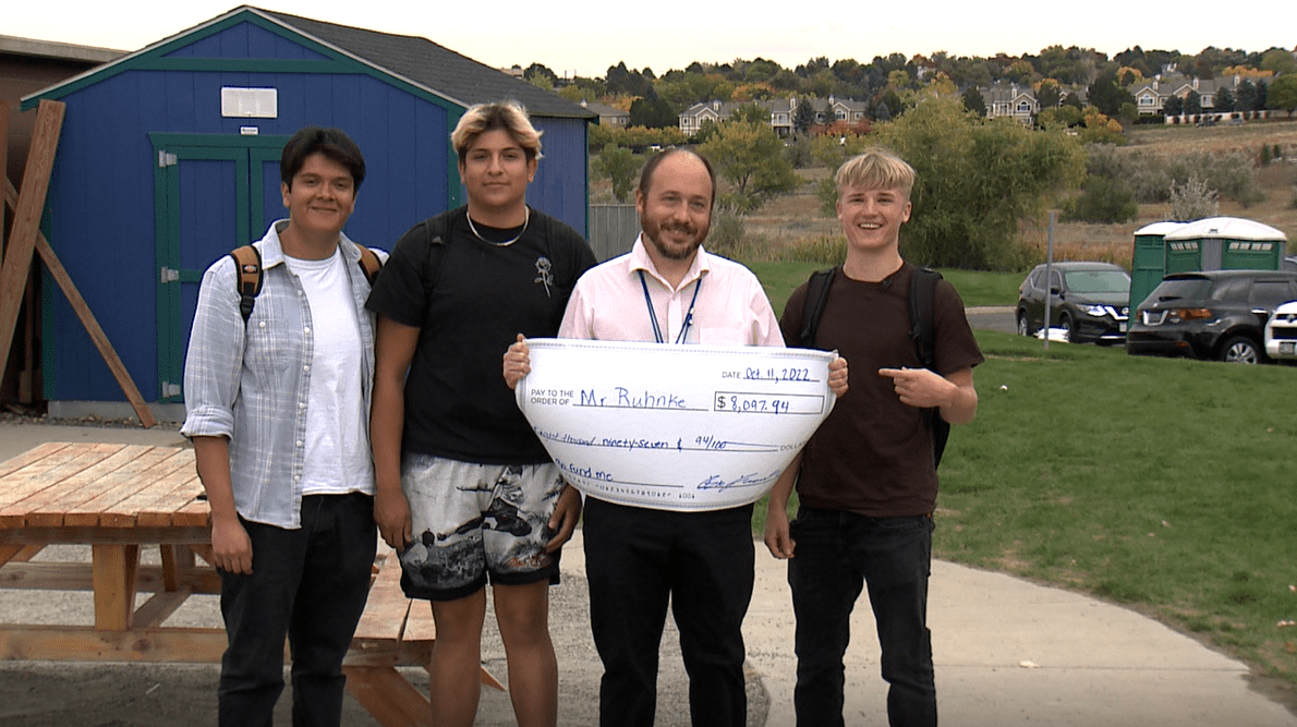 Teacher receives check from students