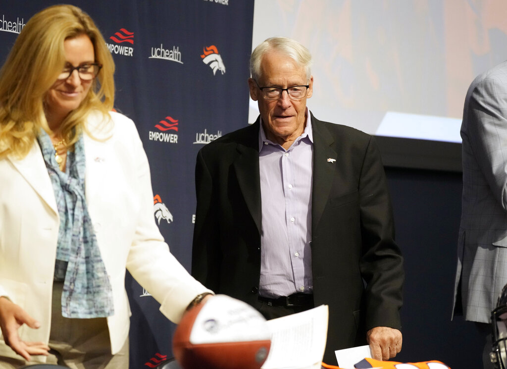 Rob Walton, right, follows his daughter, Carrie Walton-Penner, and other members of the Walton-Penner Family Ownership Group, into a news conference at the NFL football team's headquarters Wednesday, Aug. 10, 2022, in Centennial, Colo.