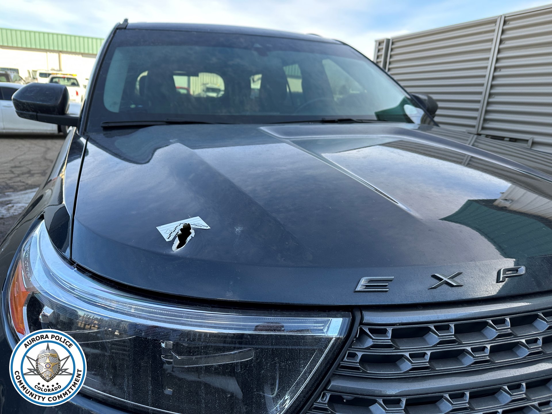 Police Ford SUV with bullet hole in hood