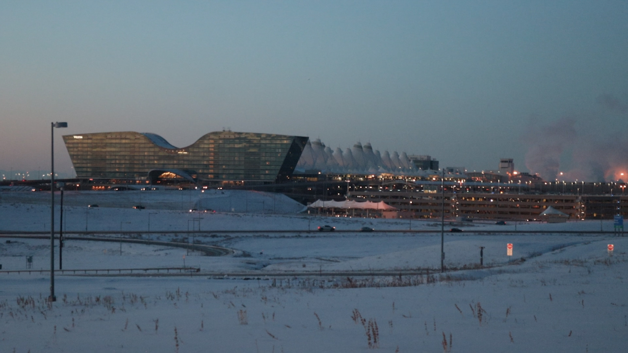 Snow covers Denver International Airport and the surrounding grounds