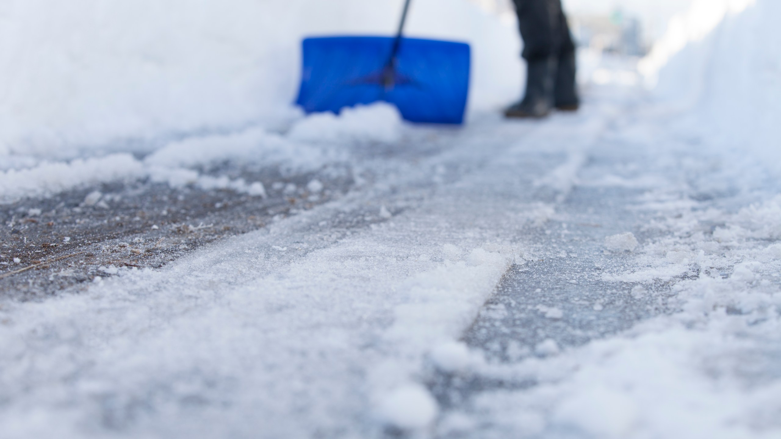 man removing snow with a shovel