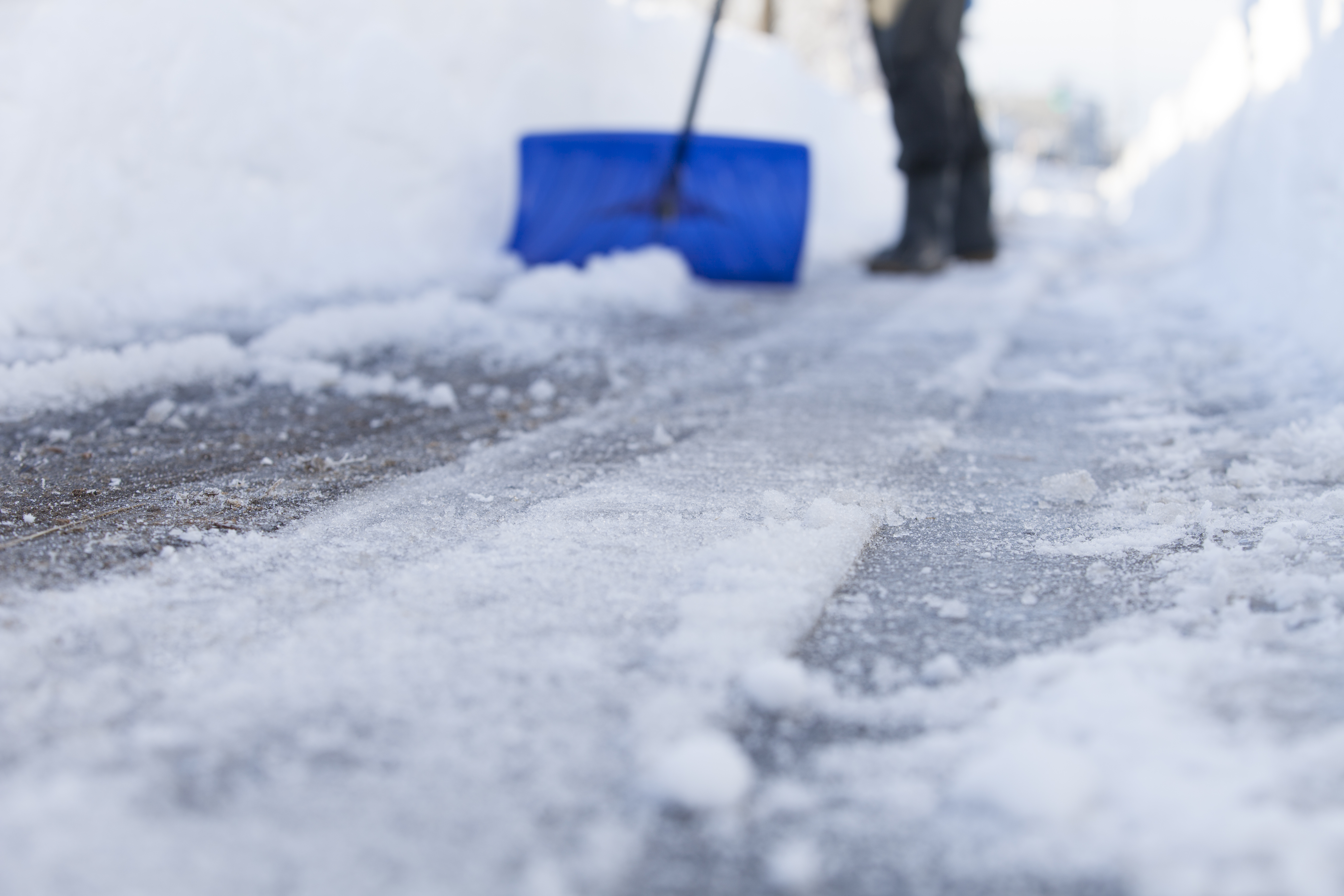 man removing snow with a shovel