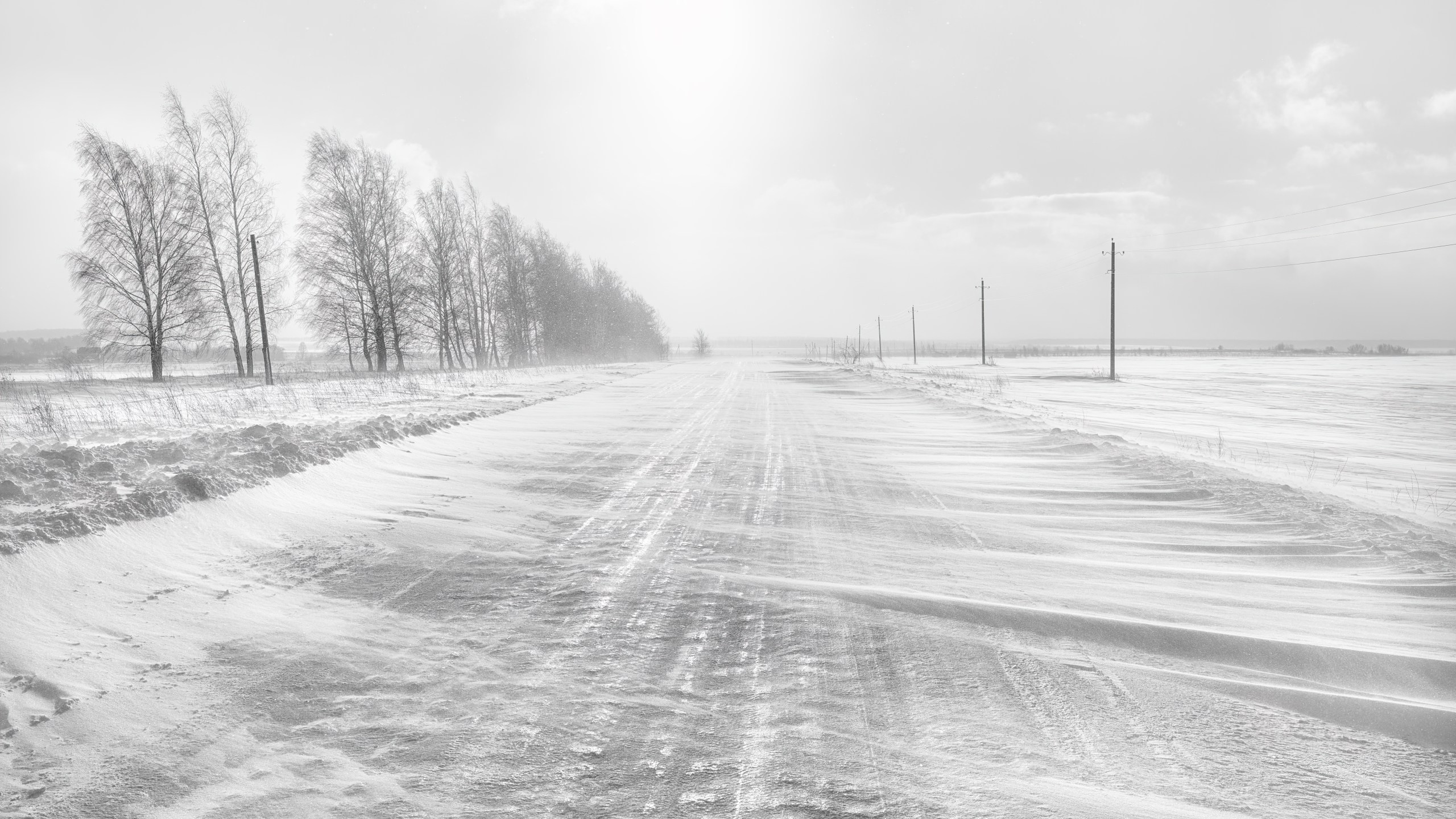 Icy winter road. A blizzard is sweeping the road.