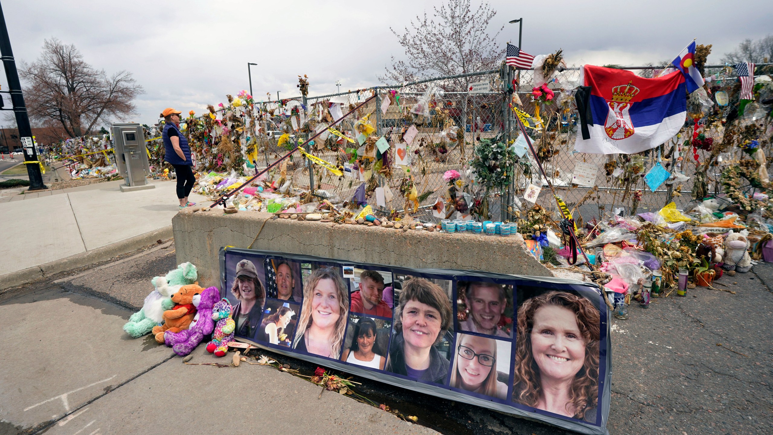 Tributes cover the temporary fence around the King Soopers grocery store