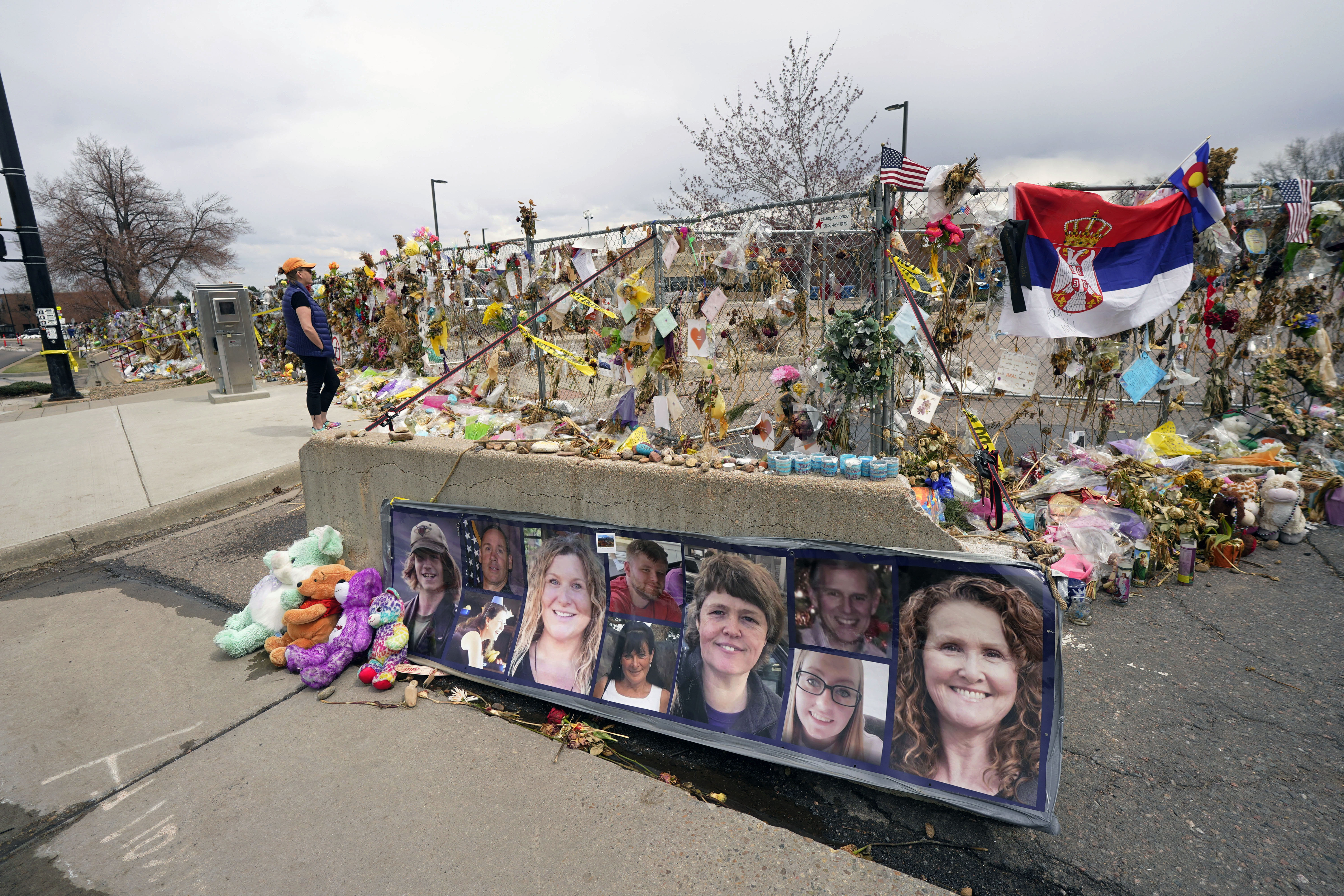 Tributes cover the temporary fence around the King Soopers grocery store