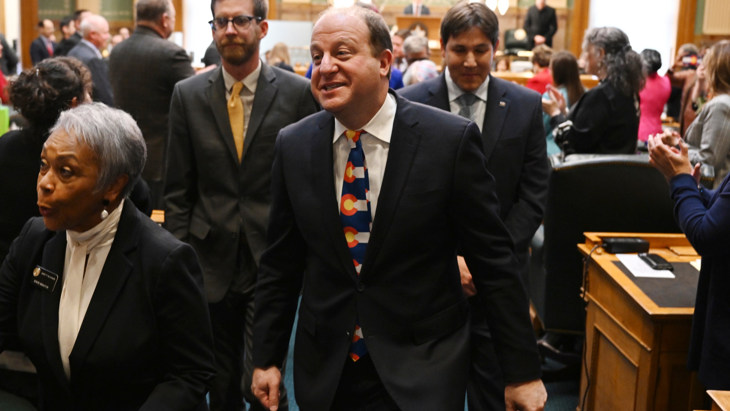 Colorado Gov. Jared Polis leaves the House of Representatives chamber