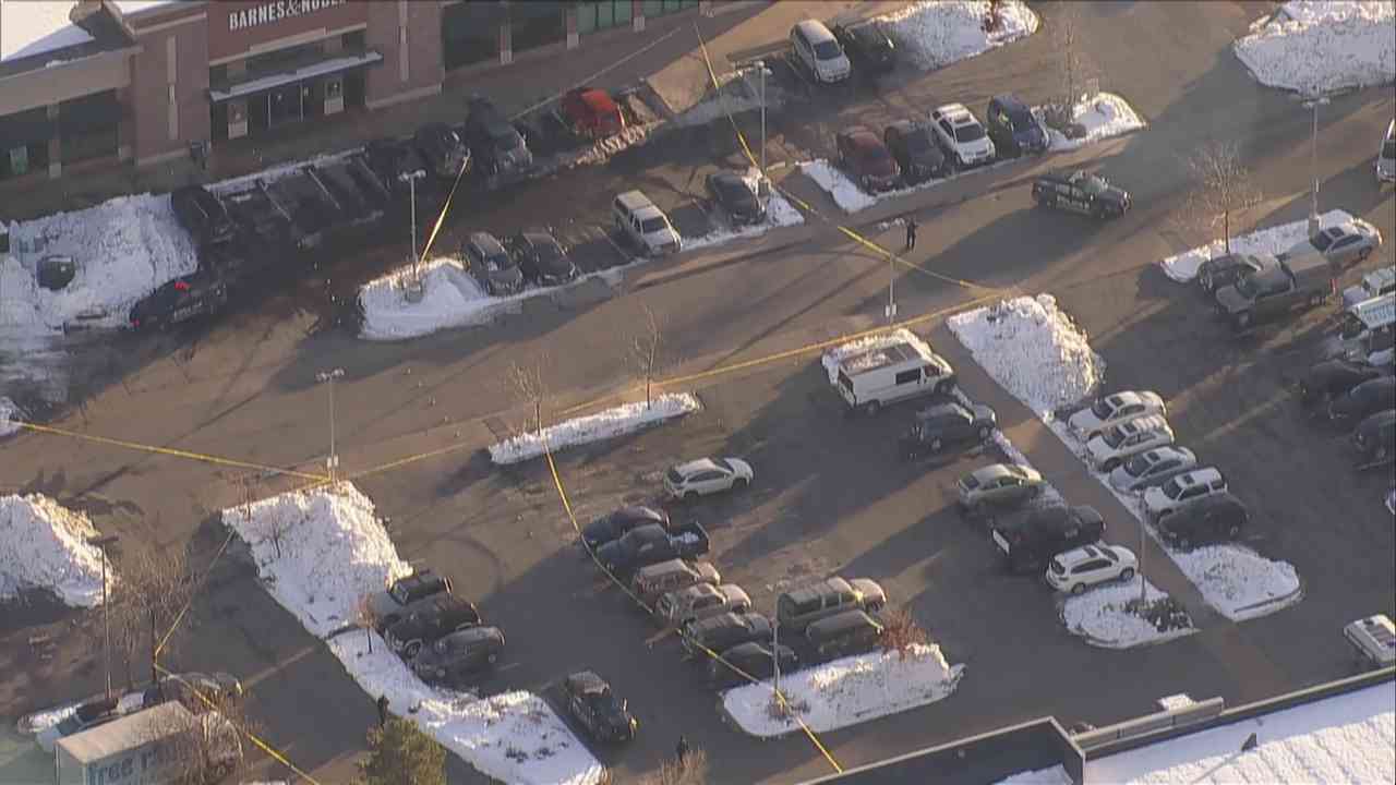 Aerial view of crime scene tape in an occupied parking lot of a Barnes & Noble store