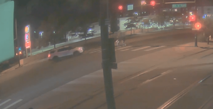 Night suveillance video of a Denver Police Department patrol vehicle in the roadway