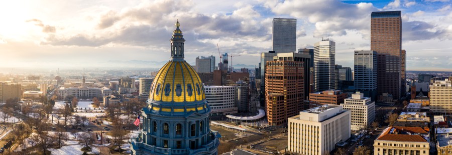 Colorado Capitol gold dome and Denver Skyline at sunset