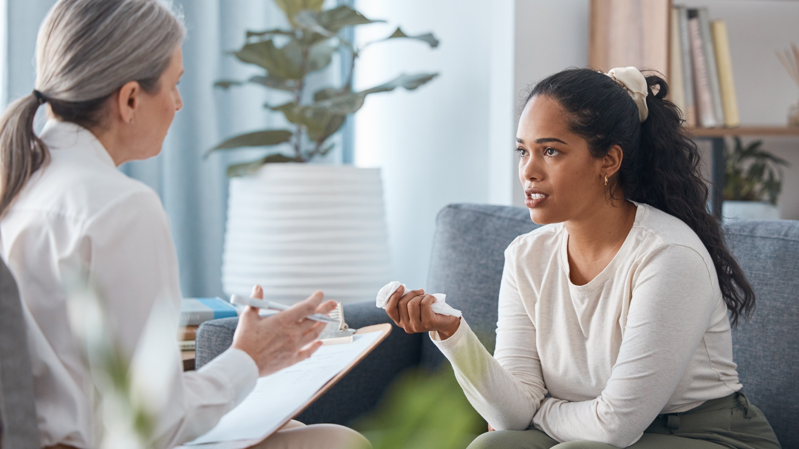 Shot of an attractive young woman sitting and talking to her psychologist during a consultation