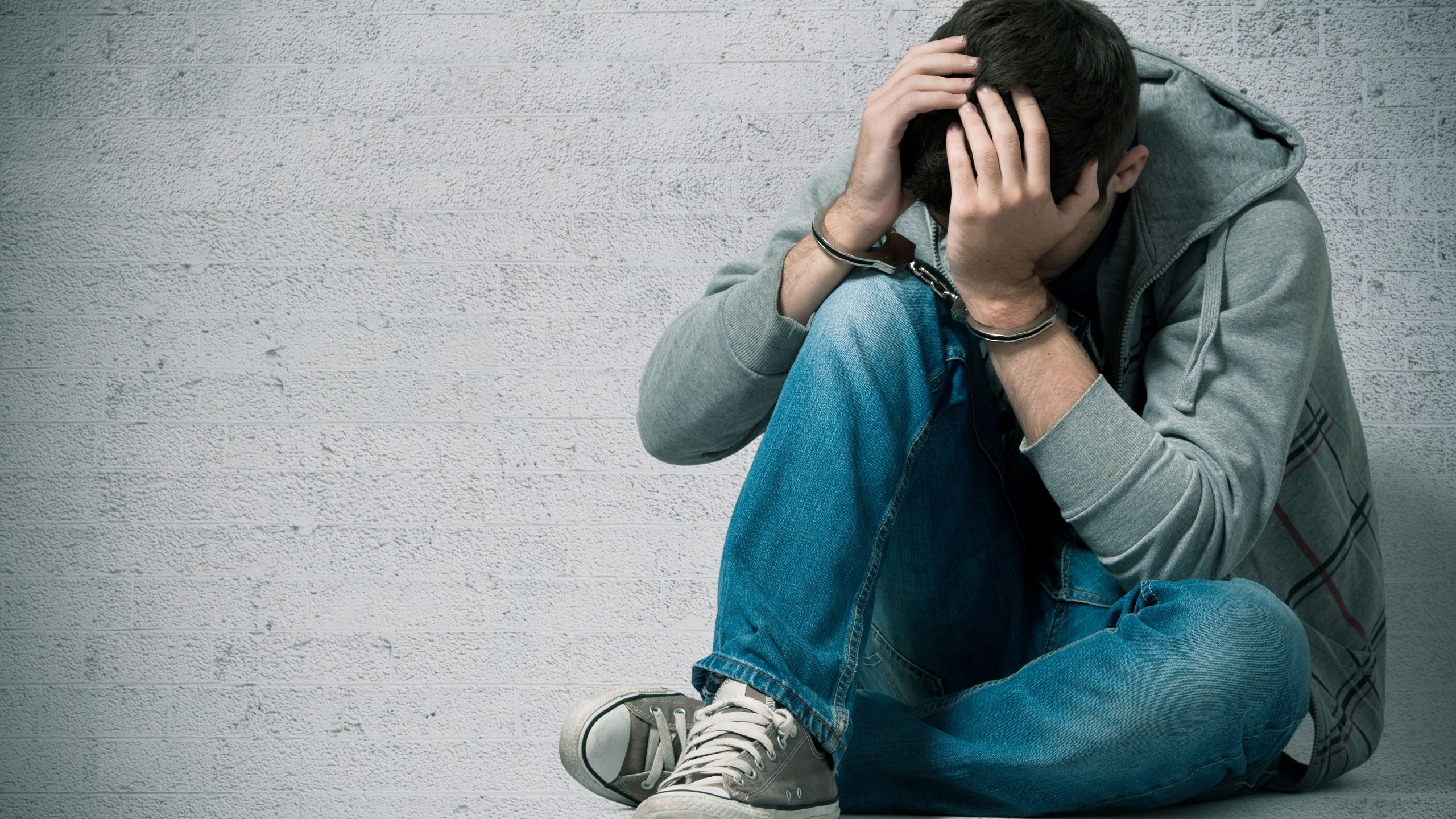 A picture of a young man handcuffed