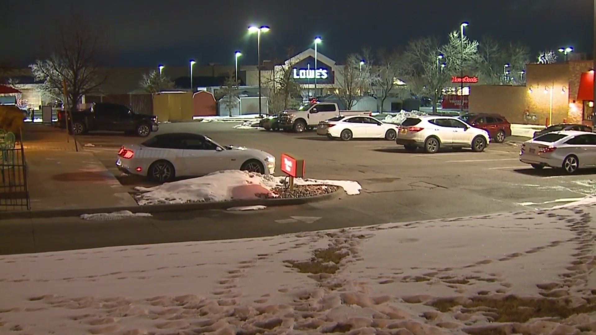 Large shopping center parking lot with a Lowe's and other businesses