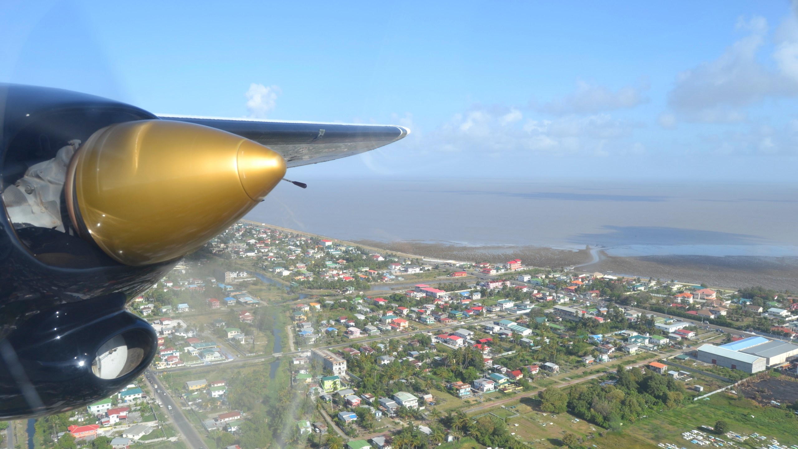 Georgetown, Guyana is seen over the propeller of a plane